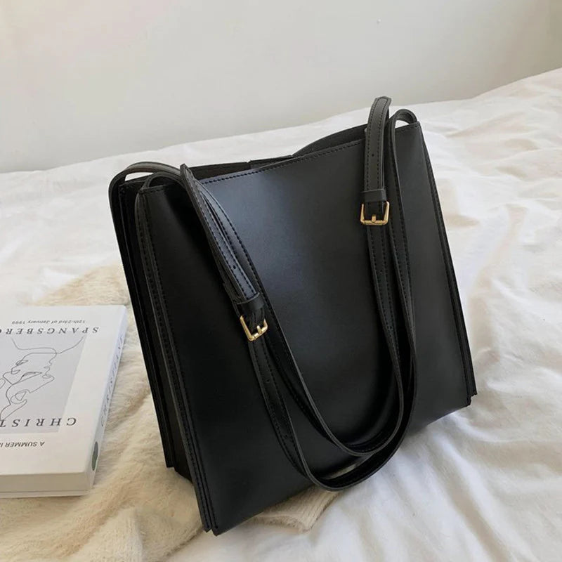 Solid Deep Black Minimalist Vertical Rectangular Shoulder Carry Tote with Warm Metallic Band Fixtures and Wide Open Top Storage Cavity Handbag