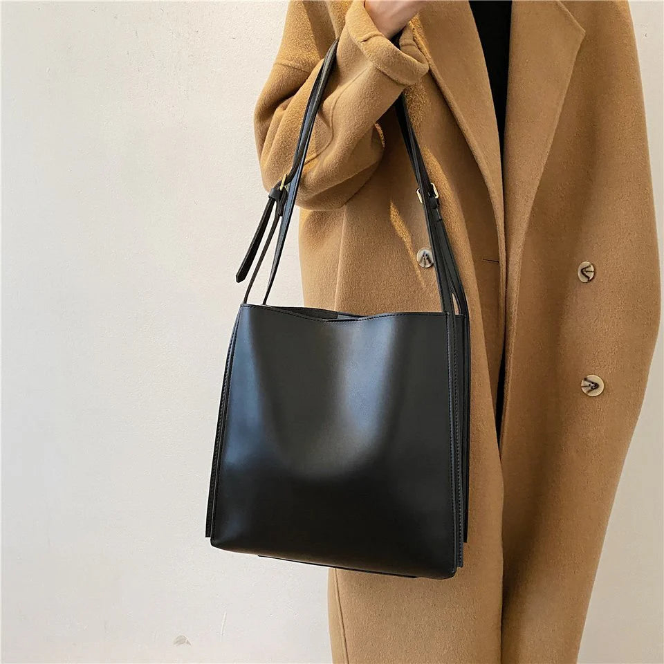 Solid Deep Black Minimalist Vertical Rectangular Shoulder Carry Tote with Warm Metallic Band Fixtures and Wide Open Top Storage Cavity Handbag