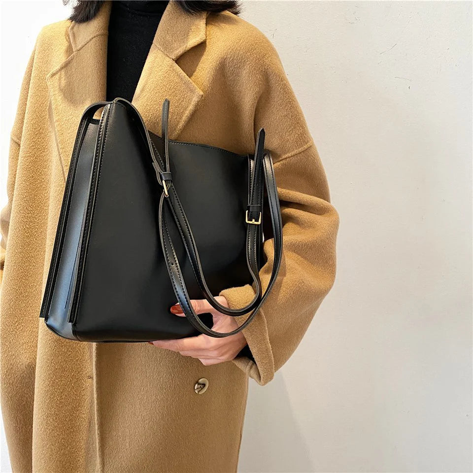 Solid Deep Black Minimalist Vertical Rectangular Shoulder Carry Tote with Warm Metallic Band Fixtures and Wide Open Top Storage Cavity Handbag